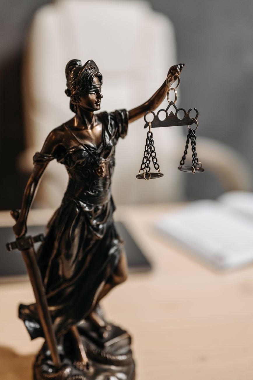 Bronze scales of justice on an attorney's desk